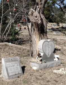 heart-shaped headstone and christmas decorations in tree